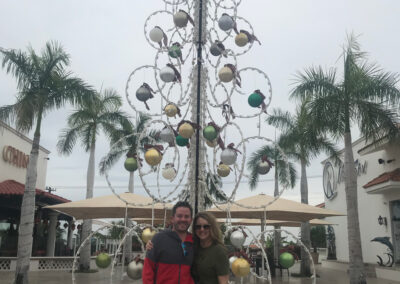 Kristina Bumgardner, nurse recruiter at Uniti Med standing in front of a holiday tree.