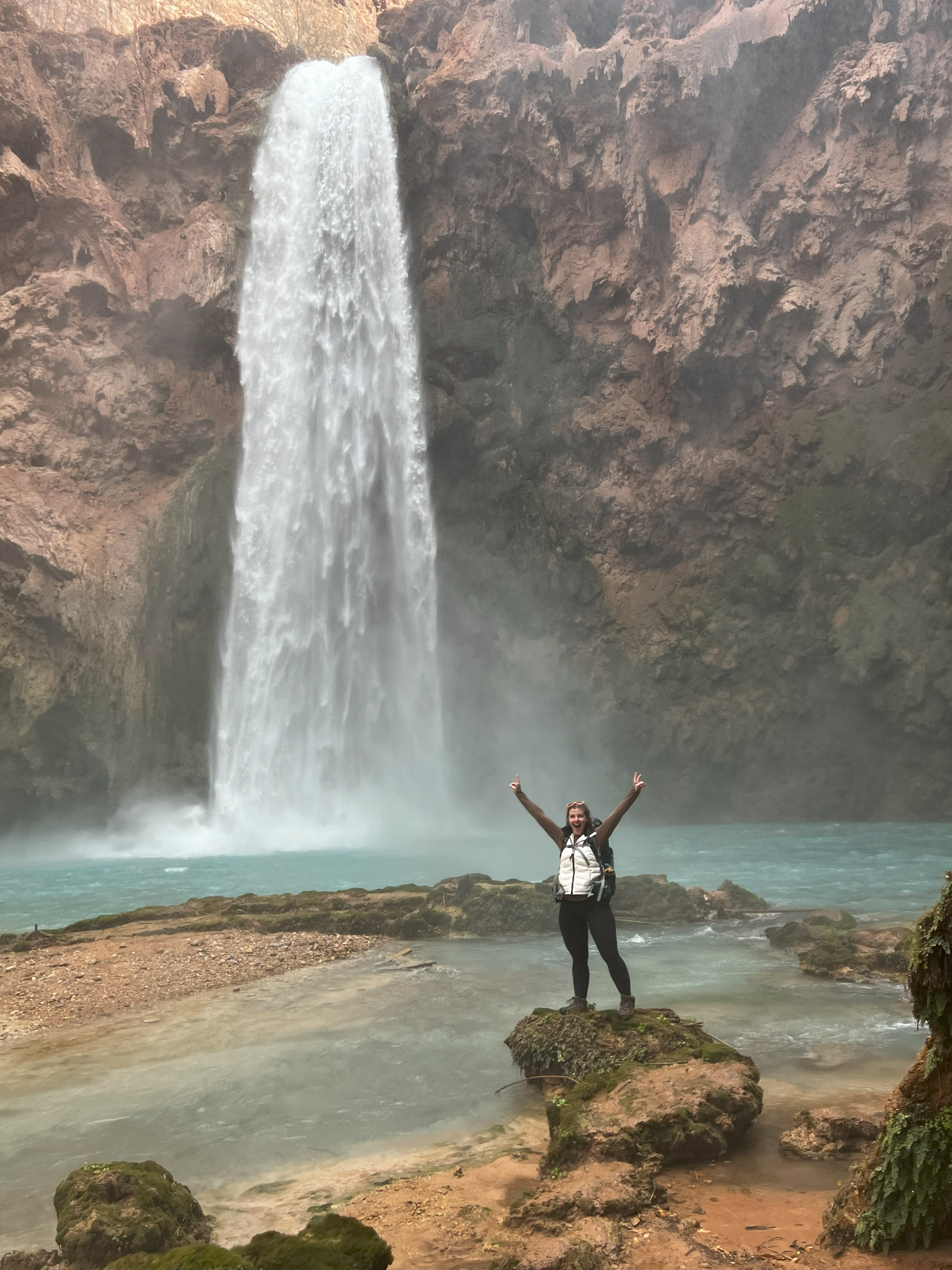 Travel nurse standing near a waterfall