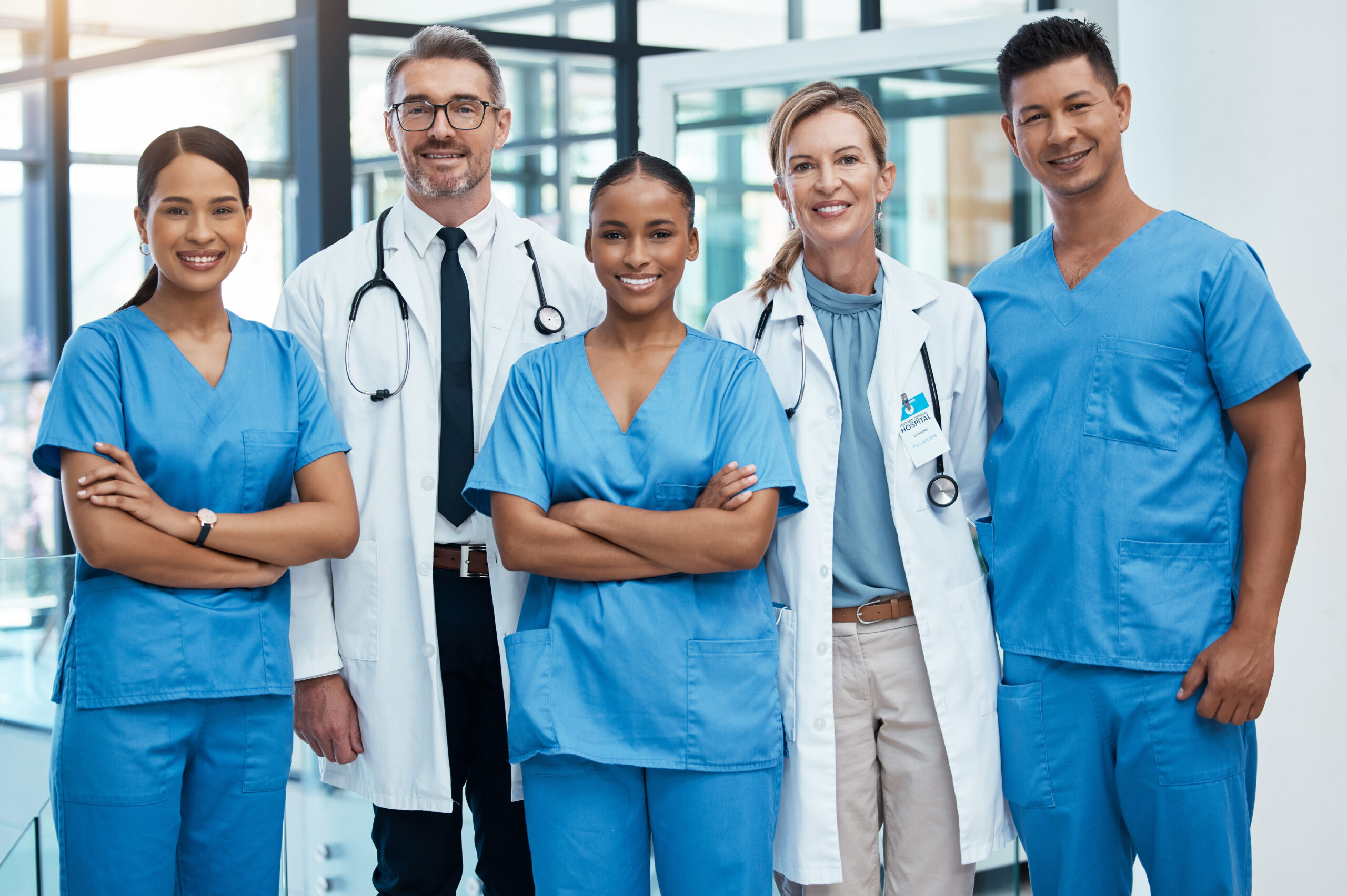 Happy doctors and nurse smile at a hospital with support, teamwork and collaboration with diversity. Team of expert medical professionals smiling at work together at clinic in the healthcare industry Medial team